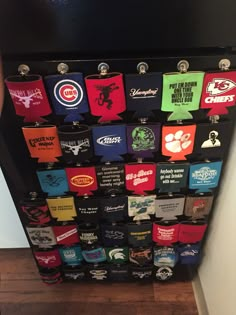 a display case filled with lots of different types of t - shirts on top of a wooden floor