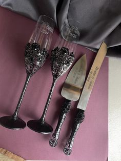 three wine glasses and a knife on a pink table cloth next to a silverware