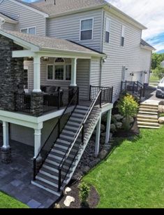 an aerial view of a two story house with stone and metal balconies on the front porch