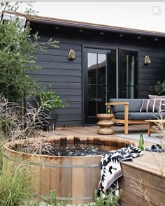 a backyard with a hot tub and patio furniture