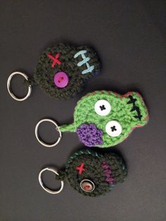 two crocheted monster keychains sitting next to each other