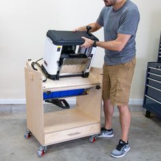 a man standing next to a box with a machine on it's back end