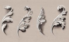 four different metal designs on a white surface, each with an ornate design and leafy leaves