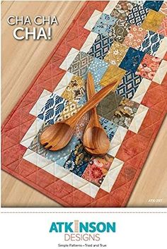 the book cover shows two wooden spoons on a patchwork table runner