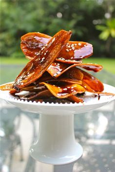 a white plate topped with lots of food on top of a glass table covered in sauce