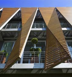 an apartment building with wooden slats and balconies