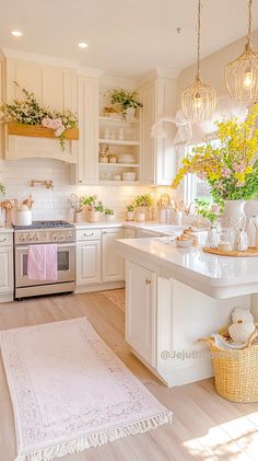 a kitchen filled with lots of white cabinets and counter top next to a stove top oven