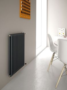 a white dining room table and chairs with a radiator in the corner next to it