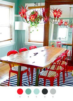 a dining room with red chairs and a wooden table