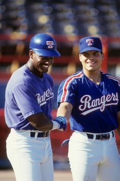 two baseball players standing next to each other