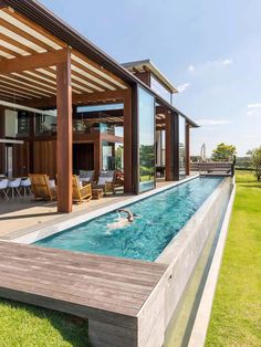 an outdoor swimming pool in the middle of a lawn