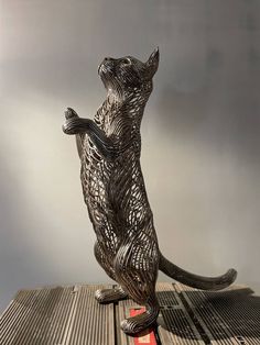 a metal sculpture of a dog on its hind legs