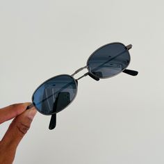 These are mini oval sunglasses featuring a matte silver metal frame with dark blue mirror lens.  This style is unisex.   *These frames are meant to fit small on the face as it was a very popular style in the 90s.  (please read measurements before buying)* 400 uv  Style:  MINI frame Measurements: Lens width: 42mm Lens height: 32mm Bridge: 17mm Arm temple: 140mm new vintage from the 90s includes sunglasses pouch Available in other colors Black https://www.etsy.com/listing/1314896126/ Brown/black h Vintage Black Sunglasses With Mirrored Lenses, Oval Sunglasses 90s, Silver Metal Sunglasses With Tinted Lenses, Retro Silver Sunglasses With Metal Frame, Vintage Silver Sunglasses With Metal Frame, Mini Frames, Blue Mirrors, Oval Sunglasses, Popular Style