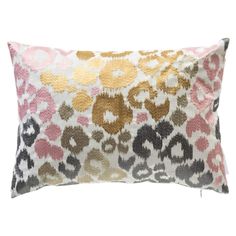 an animal print pillow with gold, pink and black spots on the front is shown