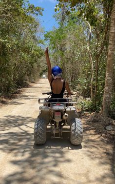 a person riding an atv on a dirt road