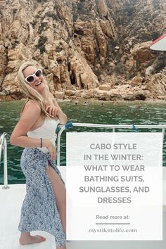 a woman standing on top of a boat next to the ocean with text that reads cabo style in the winter what to wear, bathing suits, sunglasses, and dresses