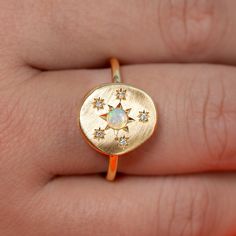 Our Pebble collection of raw, rough, beaten metals set with precious gems. Perfectly imperfect and all one of a kind. Our Opal and Diamond Snowflake Pebble Ring is set with a crystal opal, surrounded by star set G/VS diamonds. Pebble measures 14mm x 12.5mm. Band width 1.5mm. Metal weight 4.6 grams approximately. Pictured with a matte band. For a high shine finish on the band, please leave a note at checkout.