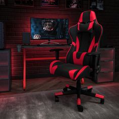 a gaming chair in front of a tv with the image of a demon on it