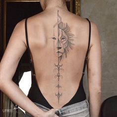 a woman with a sun tattoo on her back