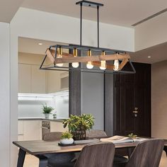 a dining room table with some chairs and a potted plant on top of it