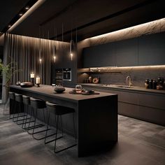 a modern kitchen with black cabinets and counter tops, lights hanging from the ceiling over the island