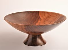 a wooden bowl sitting on top of a table