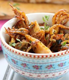 a bowl filled with fried food on top of a table