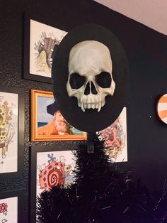 there is a skull with a hat on it's head hanging from the wall