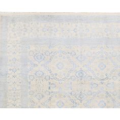 an antique rug with blue and white colors