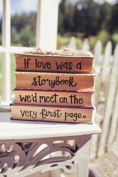 a stack of books sitting on top of a white table