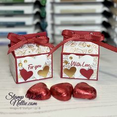 two valentine's day boxes with chocolates tied to them