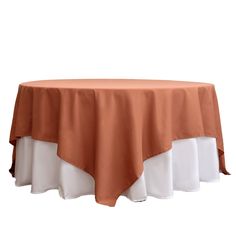 an orange and white table cloth on top of a round table