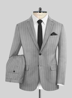 Dive into the realm of understated sophistication with our Napoleon Como Bar Gray Wool Suit. This ensemble is meticulously crafted from a luxurious wool blend, offering a smooth, breathable fabric that's delightfully soft to the touch and ensures comfort without feeling restrictive. Featuring a subtle striped pattern across a palette of gray shades, this suit is a testament to refined style. It’s exquisitely tailored to not only fit comfortably but also to enhance your silhouette, providing enough space for movement while maintaining warmth. Perfect for any scheduled event or special occasion, this suit allows you to express your sartorial elegance effortlessly.  Look Includes    Napolean     Como     Bar     Gray     Wool  Fabric  Two Button Jacket Style  Notch Lapel  Horn Royal Black But Gray Shades, Grey Wool Suit, Refined Style, Button Jacket, Wool Suit, Jacket Buttons, Wool Fabric, Jacket Style, Breathable Fabric