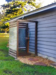 an outhouse with a door open on the grass