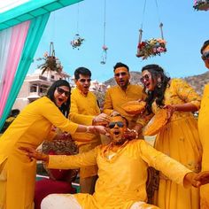 a group of people dressed in yellow posing for a photo