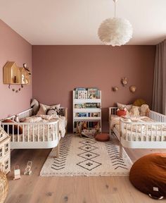 two white beds sitting in a bedroom next to each other on top of a wooden floor