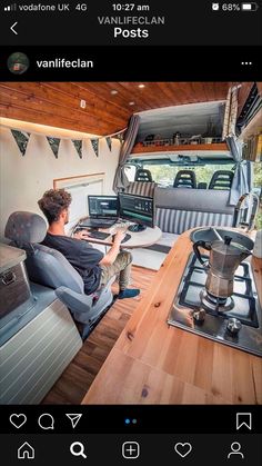 a man is sitting in the driver's seat of an rv looking at his computer