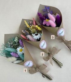 flowers are wrapped in brown paper and tied with twine