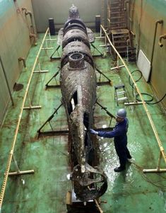 an airplane being worked on in a factory