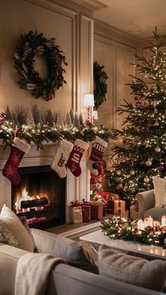 a living room decorated for christmas with stockings and candles in front of the fire place