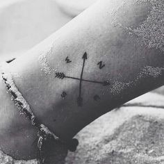 a person with a cross tattoo on their foot and the words mundiolita curids