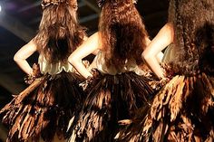 three models with long brown hair on the catwalk