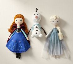 three frozen princess dolls hanging on the wall