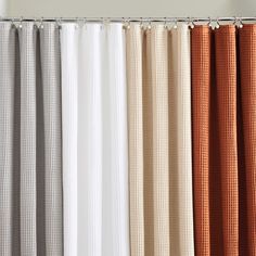 the curtains are lined up in different colors