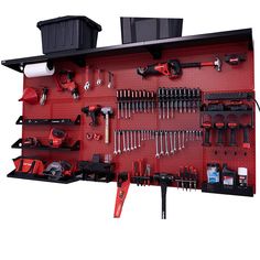 a red tool wall with tools hanging on it