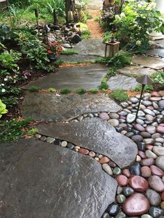 a stone path in the middle of a garden