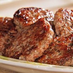 some meat patties are sitting on a plate