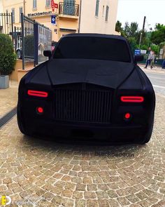 a black car is parked on the street