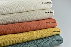 four different colors of fabric stacked on top of each other, with the words cream white fog gray rusty brown