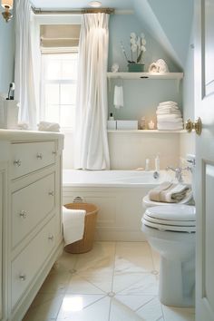 a bathroom with a toilet, sink and bathtub in the corner next to a window